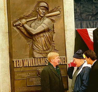 photo of bronze relief plaque of Ted Williams during dedication ceremony with people in front of it