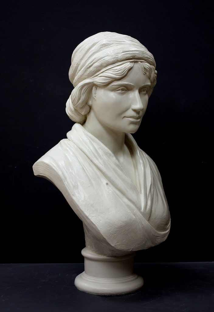 Mary Wollstonecraft IMG_0592 small file white plaster bust of female, namely Mary Wollstonecraft, against dark gray background