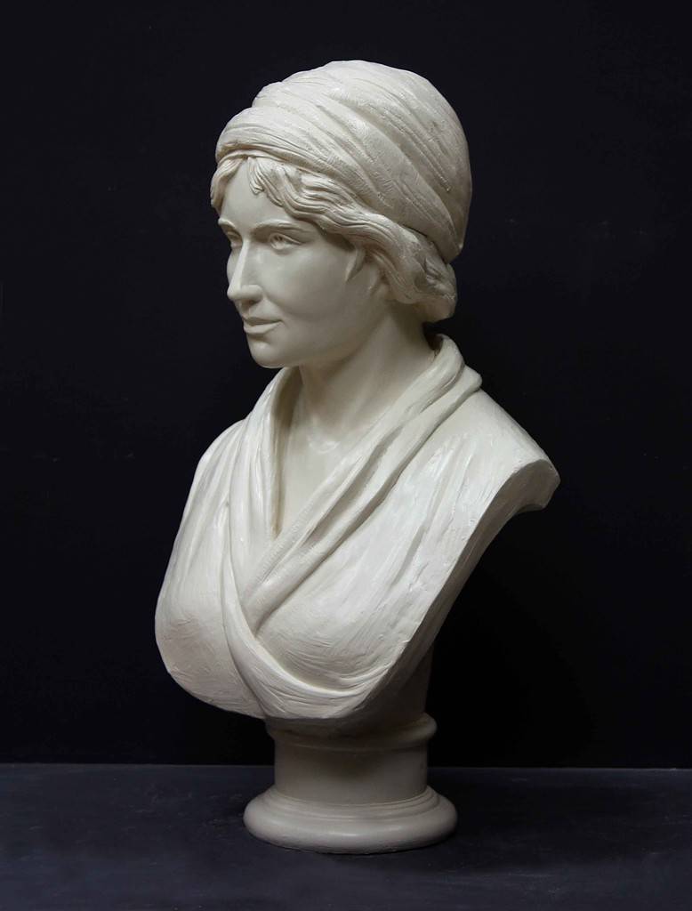 Mary Wollstonecraft IMG_0606 white plaster bust of female, namely Mary Wollstonecraft, against dark gray background