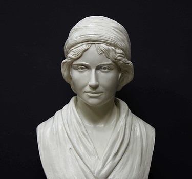 white plaster bust of female, namely Mary Wollstonecraft, against gray background