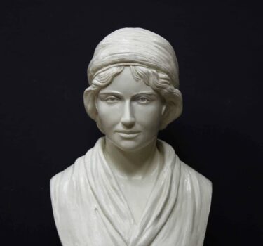 white plaster bust of female, namely Mary Wollstonecraft, against gray background