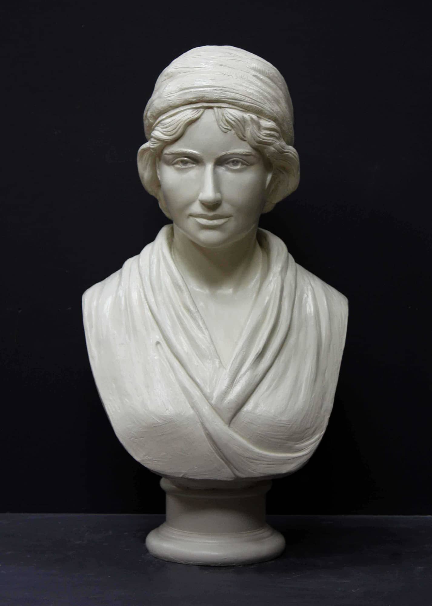 white plaster bust of female, namely Mary Wollstonecraft, against gray background