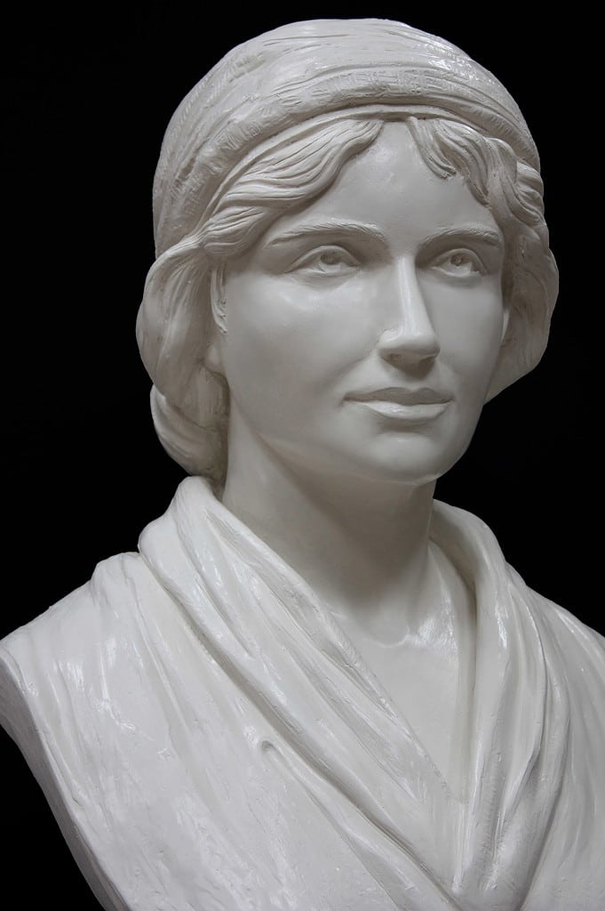 detail of white plaster bust of female, namely Mary Wollstonecraft, against dark gray background